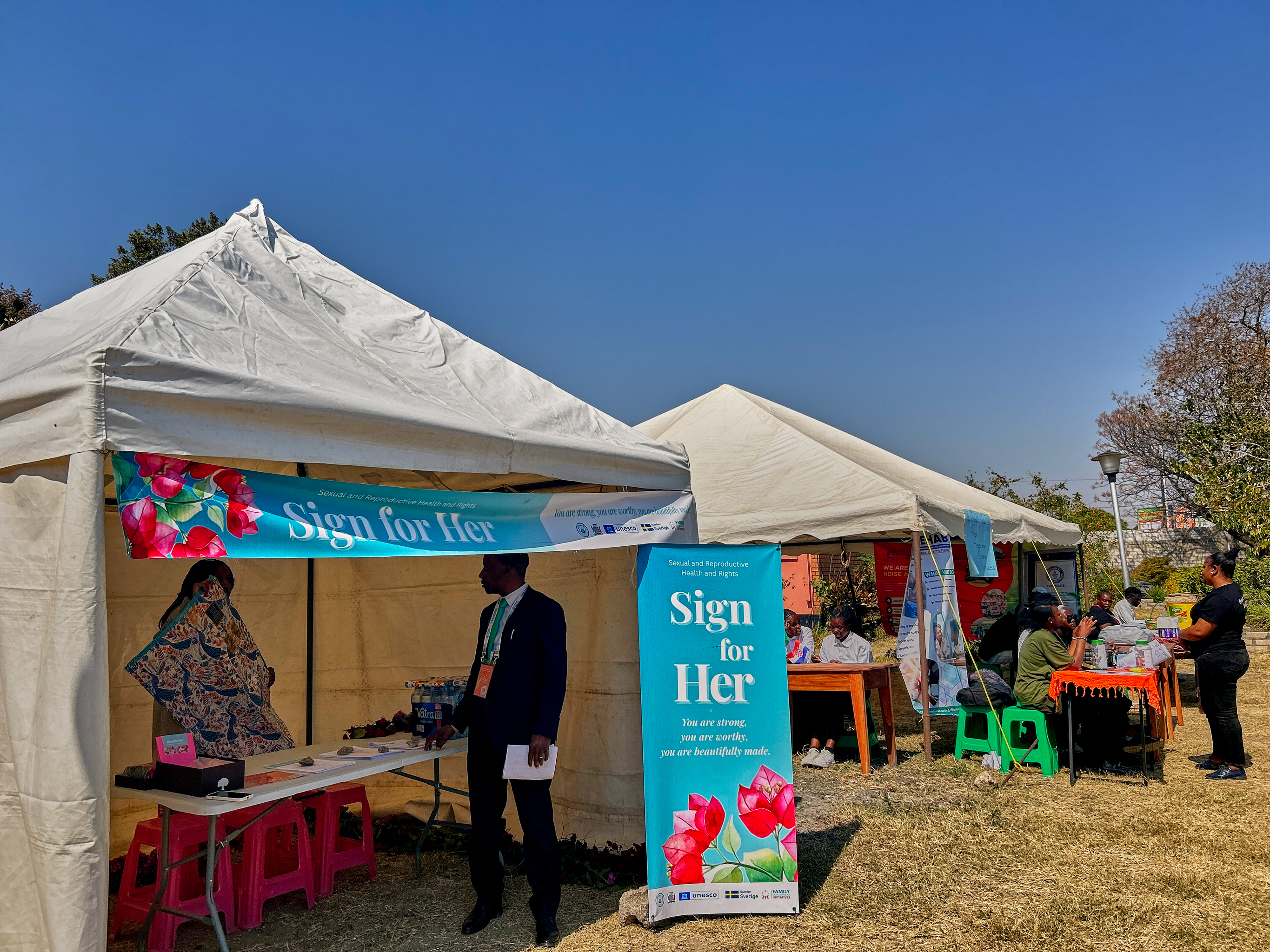 Girls in Zambia receiving menstrual pads through Sign for Her campaign